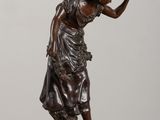 an image of a statue of a woman holding a bird on a table