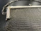 a close up of a chainmail purse on a table
