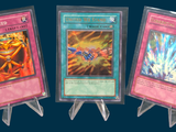 three cards are displayed in plastic holders on a blue background