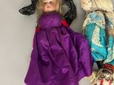 several dolls are lined up in a row on a white surface