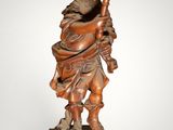 an image of a statue of a man holding a pipe