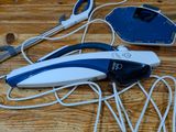 a blue and white corded device on a wooden table