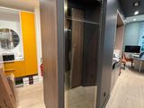 a glass door in the middle of a hallway leading to a living room