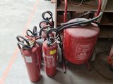 several fire extinguisors are lined up next to each other
