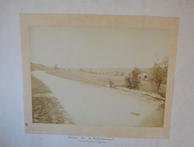 an old photo of a river running through a rural countryside
