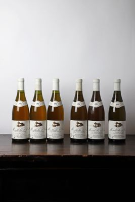 several bottles of wine are lined up on a table