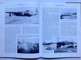 an open book with a picture of a plane in it