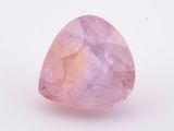 a pink quartz tear shaped stone on a white surface