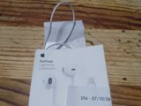 an apple earpods are sitting on top of a box on a wooden table