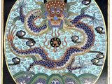 an image of a blue and black plate with a dragon on it