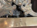 bronze sculpture of a lion on a pedestal with a plaque on the base