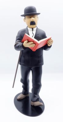 figurine représentant un homme en haut-de-forme et muni d'une canne, en train de lire un livre
