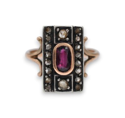 a close up of a ring with a pink stone surrounded by diamonds