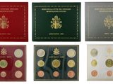 a group of six different colored coins in a box