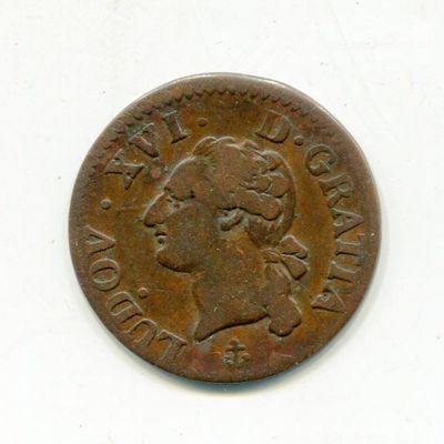 an old coin with a woman ' s face on it on a white surface