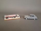 two toy cars sitting next to each other on a table