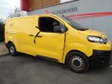 the yellow van is parked in front of a building with the door open