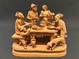 a statue of a group of people sitting around a table