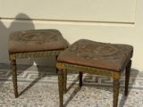 two stools that are sitting on a tiled floor