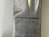 a knife that is sitting on top of a piece of metal