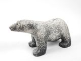 a black and white polar bear figurine on a white background