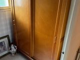a large wooden cabinet in the corner of a room