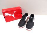 puma black and white sneakers with red box on white surface
