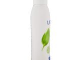 a white bottle with a green leaf on the side of it