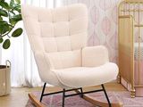 a rocking chair in the corner of a room next to a crib