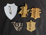 several different metal items are displayed on a black surface