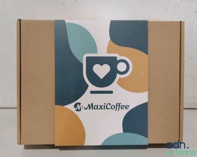 a close up of a box with a cup of coffee on it