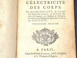 an old book that is open on a table
