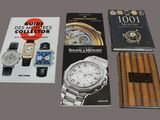 several books and a watch are sitting on a table