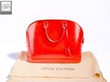 a red purse sitting on top of a white box