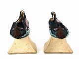 pair of antique chinese shoes on display on a white surface