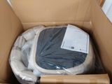 a cardboard box with a toilet in it that is wrapped in plastic