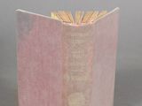 a pink book that is open on a table