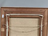an old picture frame hanging on a wall next to a window