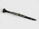 a close up of a black and silver clarinet on a white surface