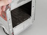 a hand that is holding a silver microwave oven