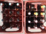 two red crates with bottles of wine inside of them