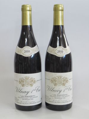 two bottles of wine sitting next to each other on a table