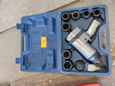 a blue tool box with tools in it on the floor