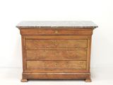 a small chest of drawers with a marble top
