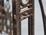 a close up view of a metal chair with a wooden seat