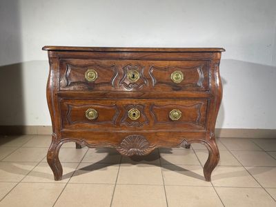 a wooden chest of drawers with brass knobs on it