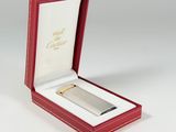 a red box with a silver lighter inside of it