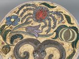 a plate with a design on it sitting on a table