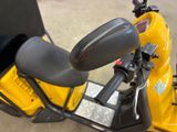 a yellow scooter with a black seat and a black seat