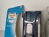a box of toothbrushes on a shelf next to a toothbrush